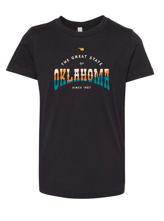 Front of youth black t-shirt with distressed Oklahoma text in orange and blue. April 2021 Oklahoma Shirt of the Month.