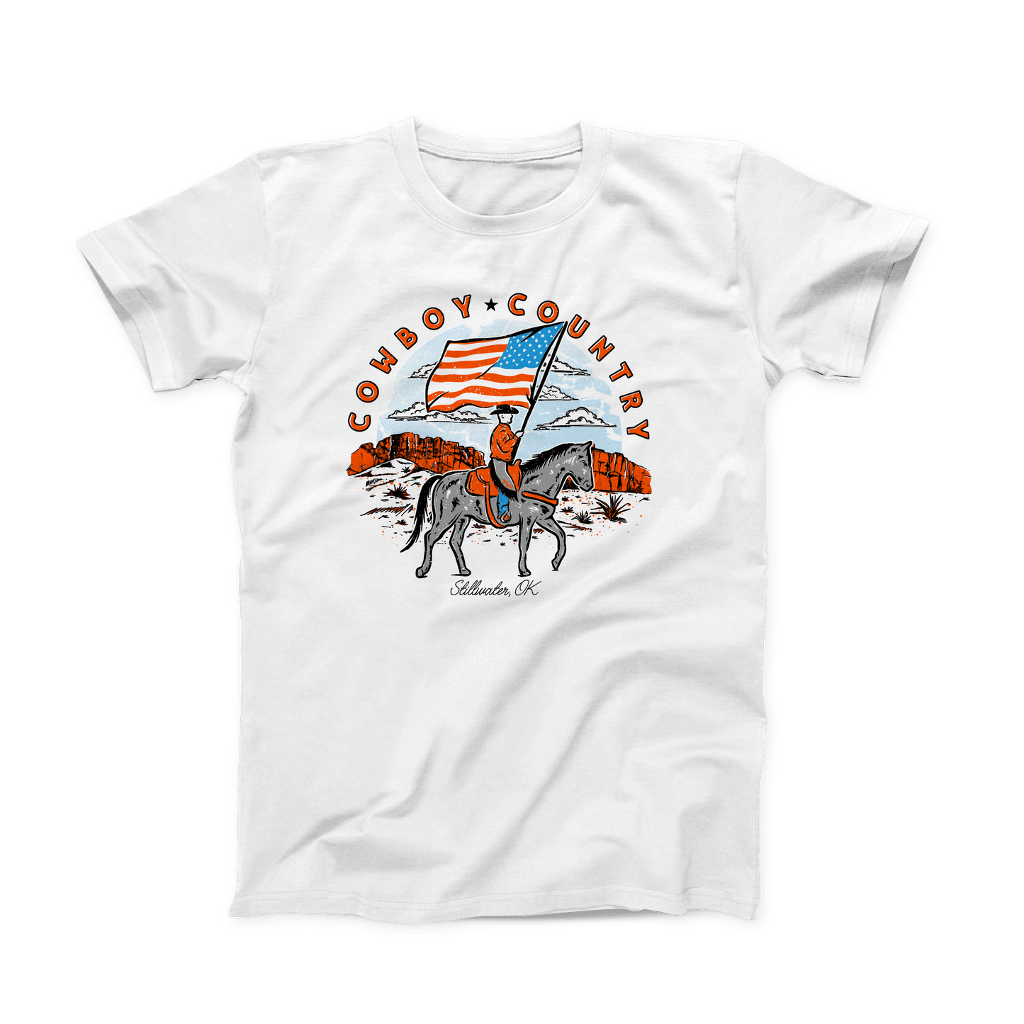 White OSU T-shirt with orange, grey, blue and black design printed on the front. The circular design is a cowboy on horseback holding the American flag. "Cowboy (star) Country" is written above the design in a half circle, in orange bold font. And "Stillwater, OK" is written in small black script font at the bottom.