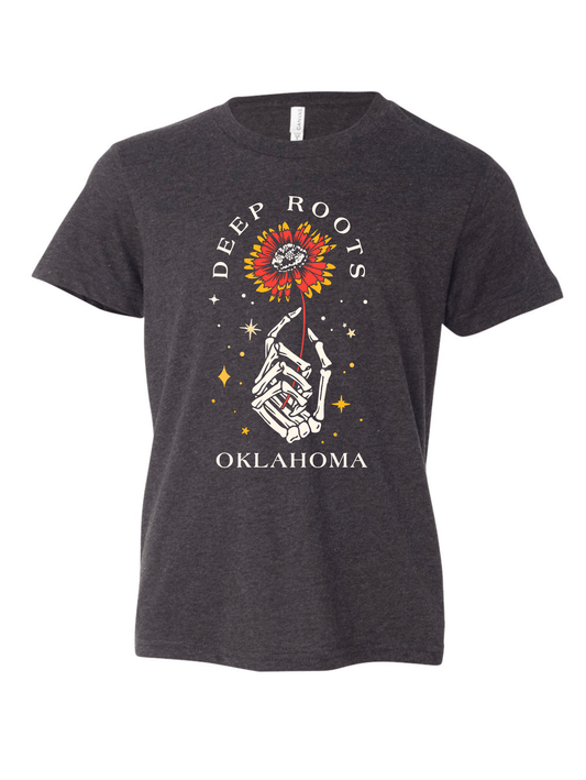 Front of youth dark grey heather shirt with skeleton hand holding Indian Blanket flower.
