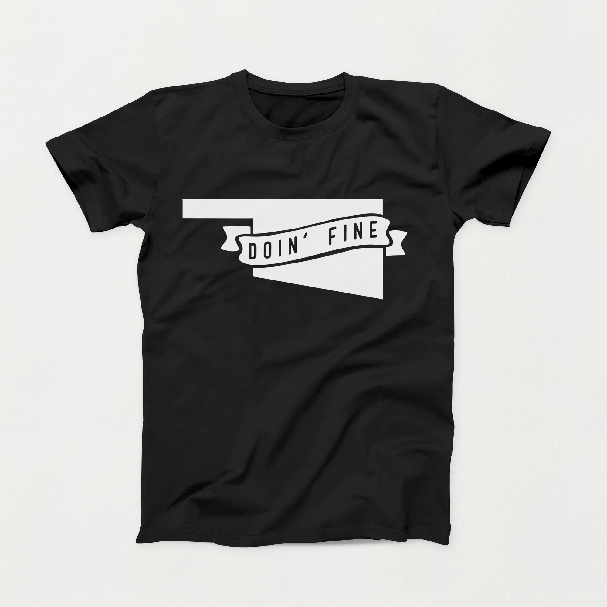 Black t-shirt with white Oklahoma outline and ribbon reading “Doin’ Fine,” Intro Shirt of the Month