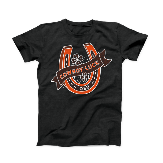 Black heather OSU shirt for March. Orange and white design of an upright horseshoe with 4 leaf clovers inside and "OSU" on the bottom. A banner with "Cowboy Luck" across the front.