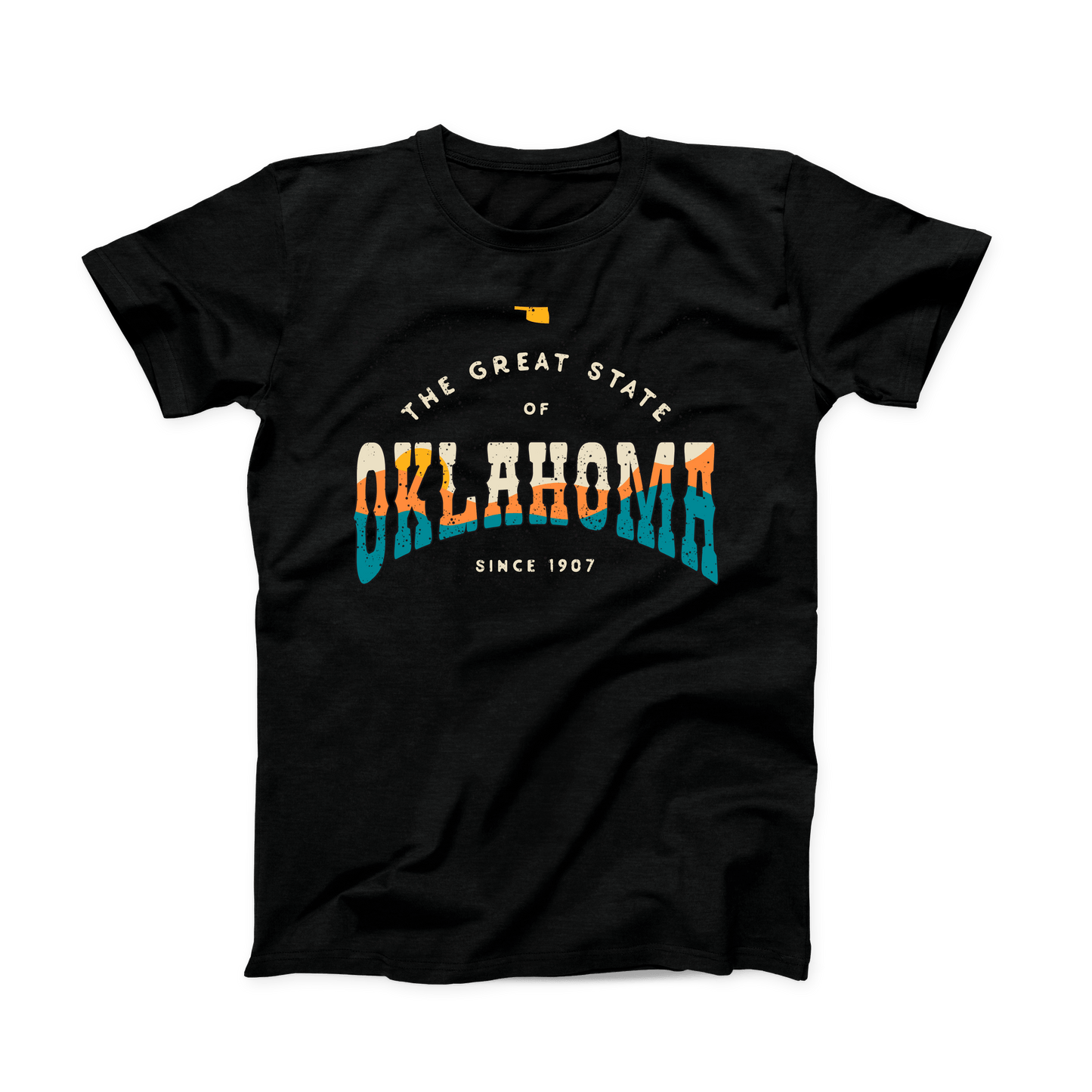 Black Oklahoma t-shirt. Small Oklahoma state shape at the top in yellow gold. "The Great State of Oklahoma since 1907" listed under the state. "Oklahoma" is the largest font on the shirt with a sunset over hills shown within the word in cream, yellow, orange, and teal. 