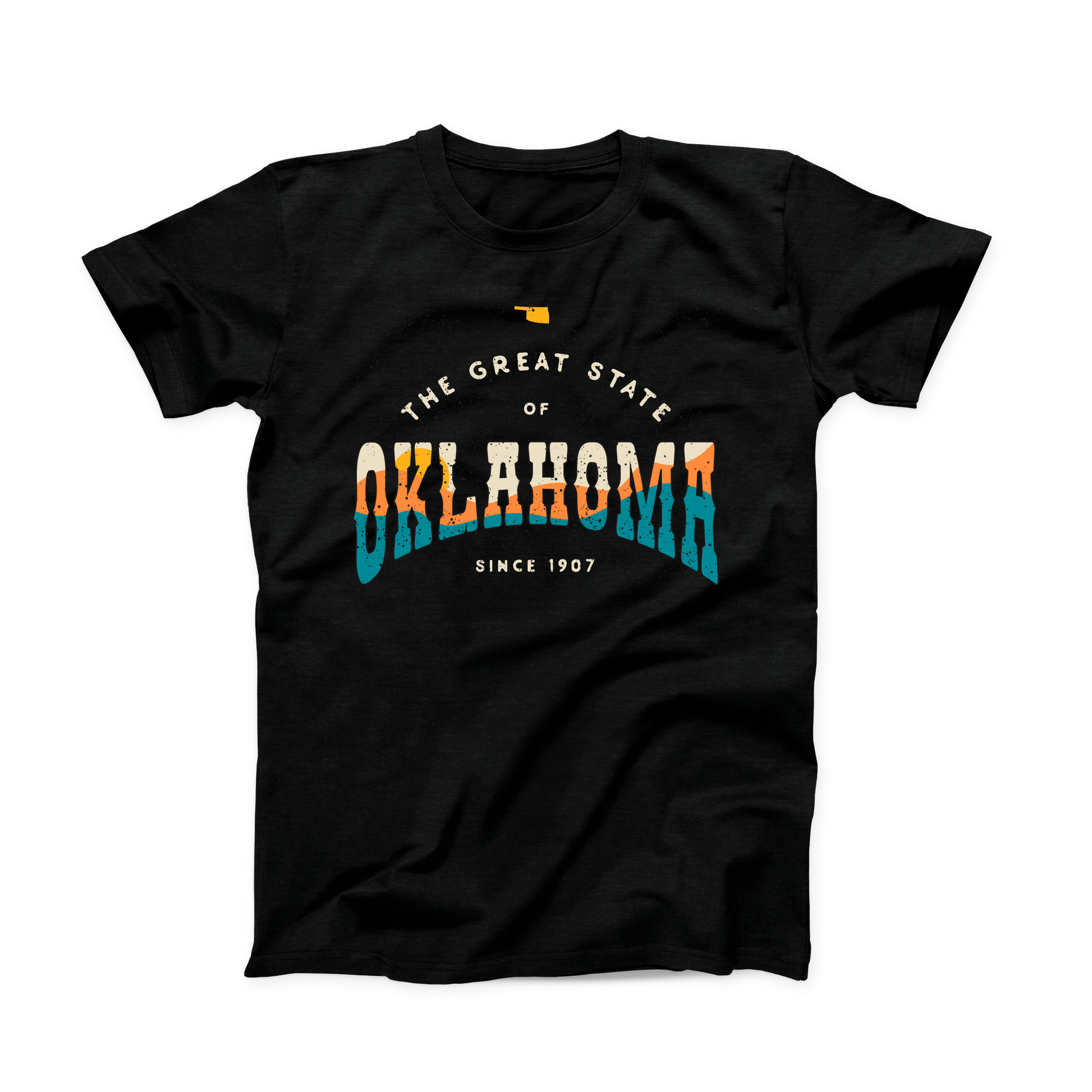 Black Oklahoma t-shirt. Small Oklahoma state shape at the top in yellow gold. "The Great State of Oklahoma since 1907" listed under the state. "Oklahoma" is the largest font on the shirt with a sunset over hills shown within the word in cream, yellow, orange, and teal. 