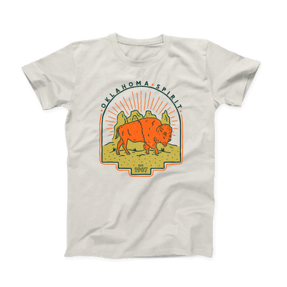 Natural colored Oklahoma T-shirt. Screen printed in gold, orange and navy. An orange bison is depicted in front of a gold canyon with the sun's rays shining behind it. In thin, curved font above the scene is "OKLAHOMA SPIRIT" in navy. And below the scene is "Est. 1907" in small font.