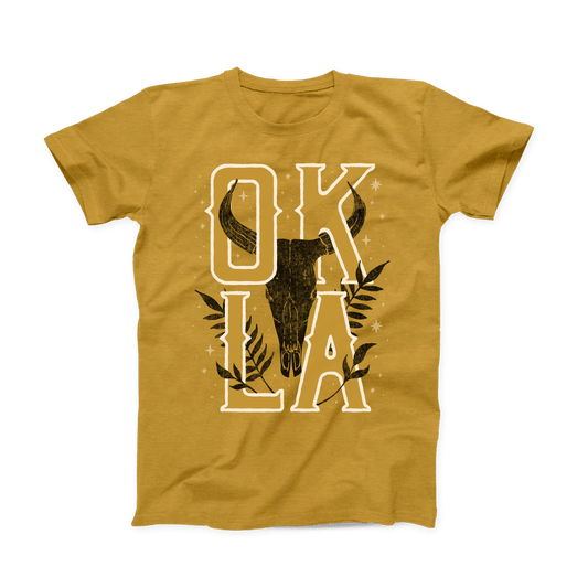 Front of heather mustard t-shirt with longhorn skull and bold OKLA lettering. August 2021 Oklahoma Shirt of the Month.