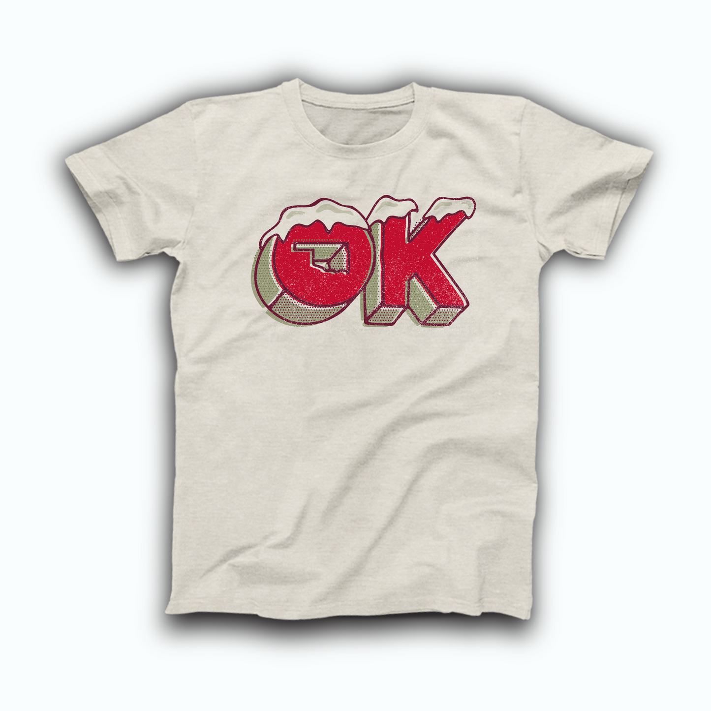 Heather Prism Natural colored Oklahoma t-shirt. The design is a pixel, red and green "OK" with snow piled on top and a cutout in the "O" of the state's shape.