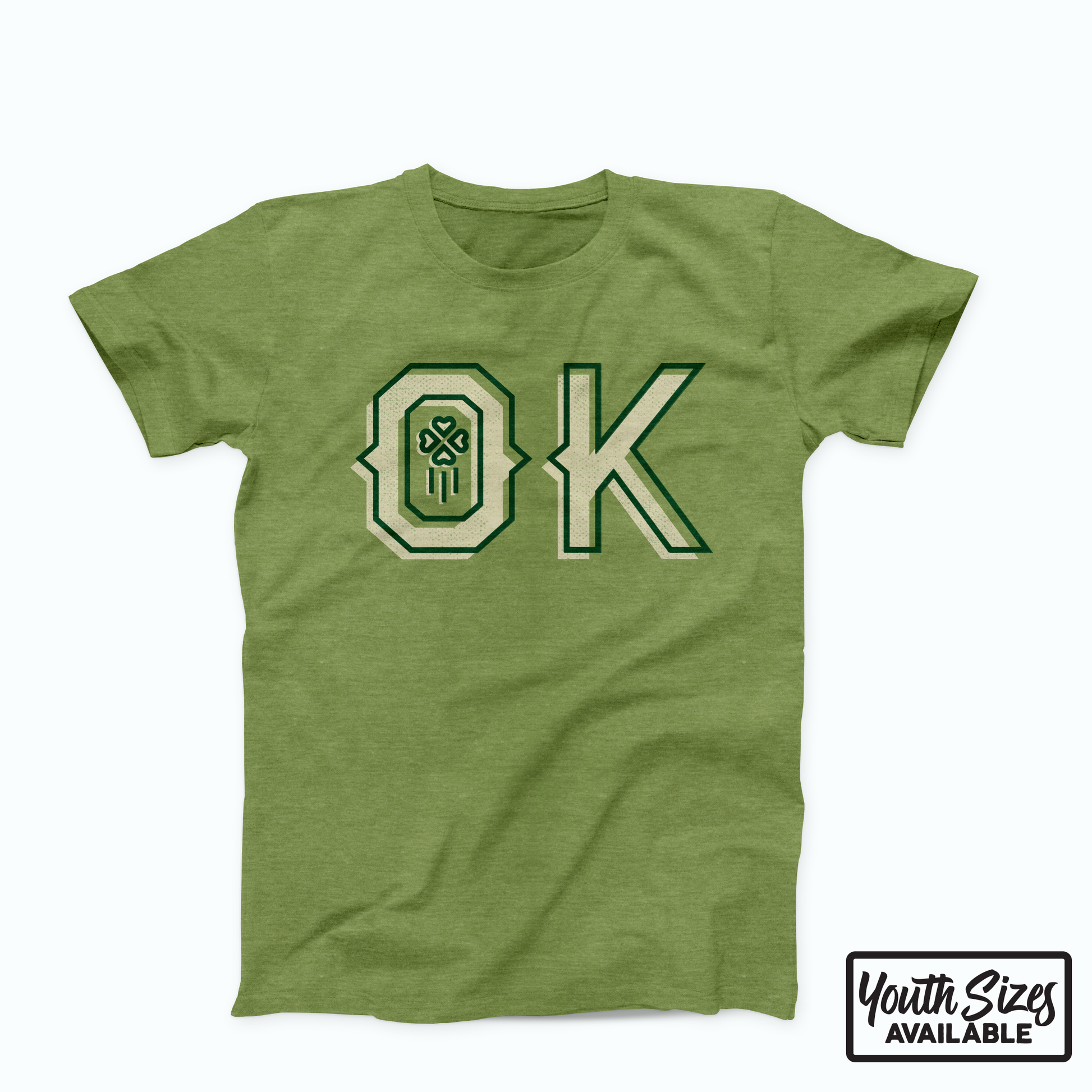 Heather Green Oklahoma t-shirt. Screen printed in cream and dark green is "OK" across the chest. Within the "O" is a 4 leaf clover with 3 thin lines below it vertically. 