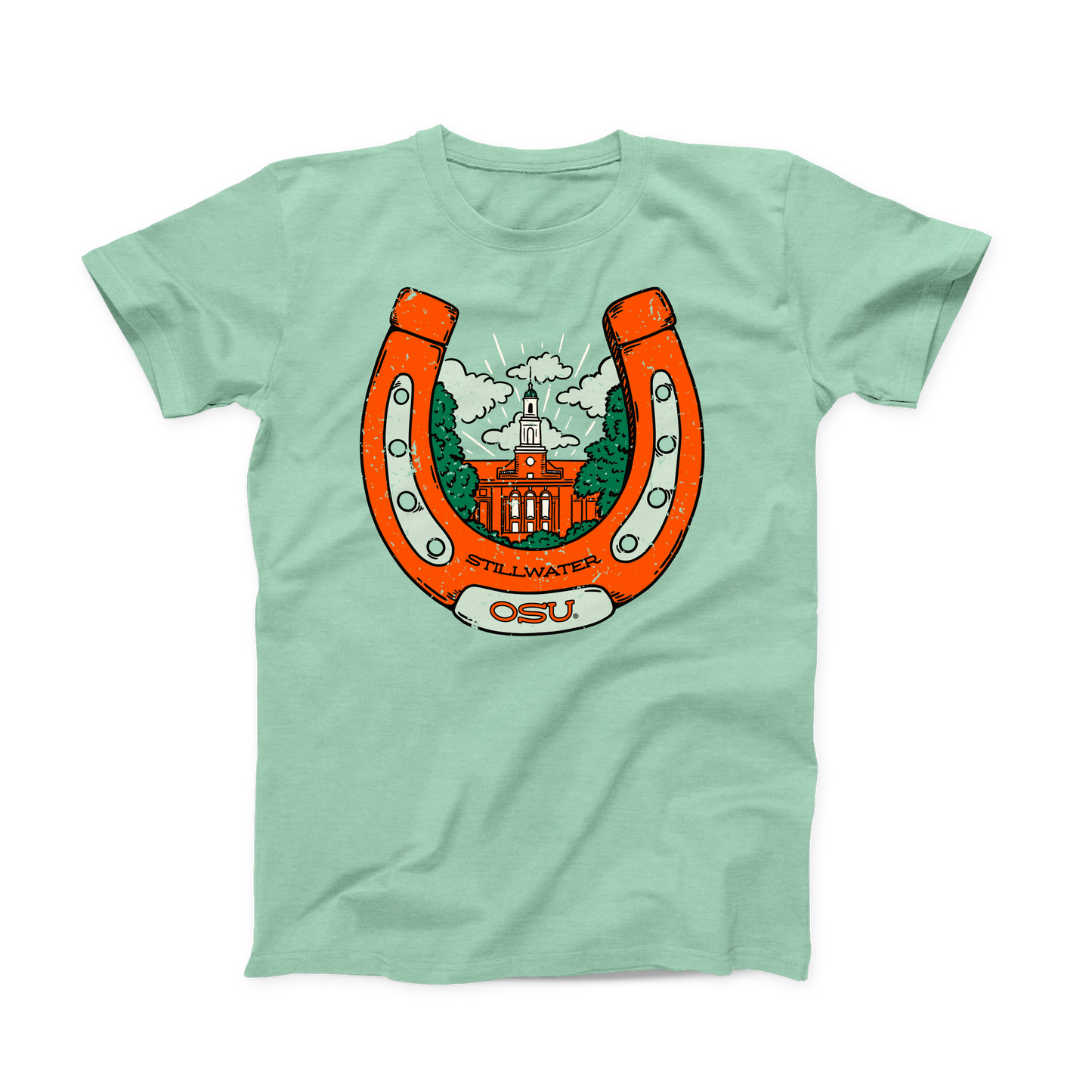 Mint green colored OSU T-shirt. Screen printed in orange is a large, upright horseshoe with "Stillwater" in small black font at the bottom, with "OSU" a little larger below that on the horseshoe. Inside the horseshoe is the Edmon Low Library building surrounded by green trees and white clouds.  